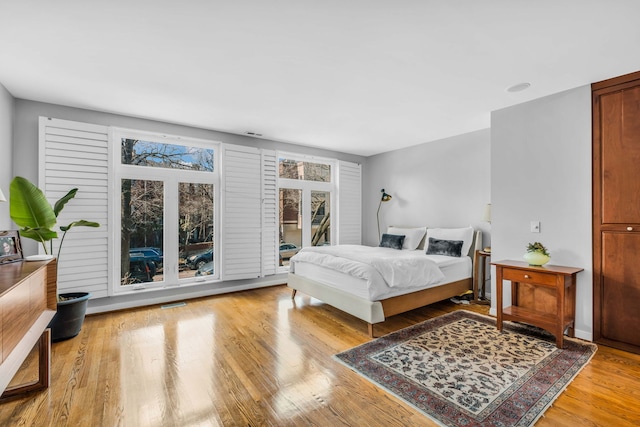 bedroom featuring light wood-type flooring and visible vents