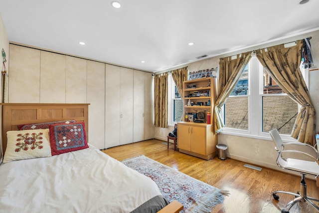 bedroom featuring light wood-type flooring, visible vents, and recessed lighting