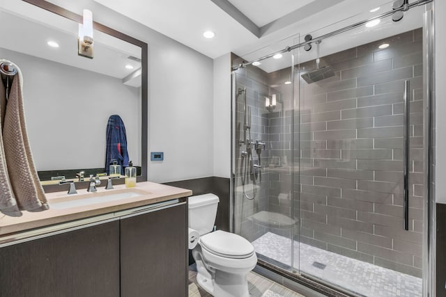 full bathroom with a stall shower, vanity, toilet, and recessed lighting