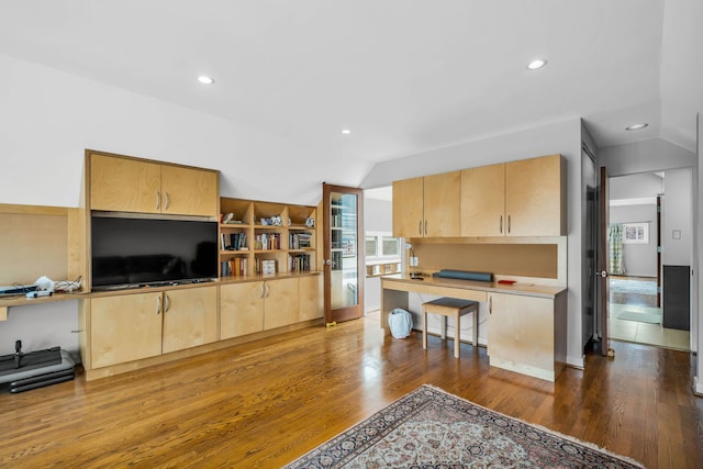 interior space with lofted ceiling, recessed lighting, and wood finished floors