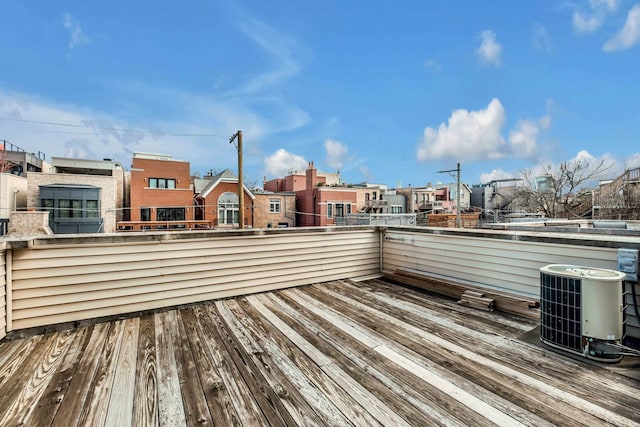 deck featuring cooling unit and a residential view