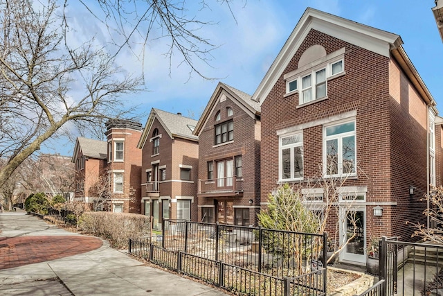 exterior space featuring fence and brick siding