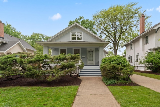 308 S Brainard Ave, La Grange, IL 60525 - view of front facade with a porch, stucco siding, and a front lawn