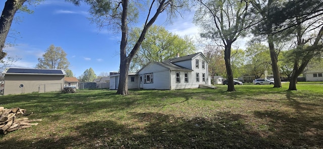 view of side of property featuring a yard and fence