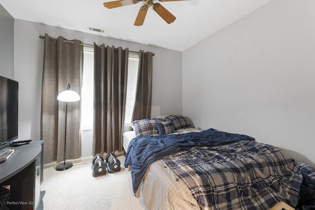 carpeted bedroom with a ceiling fan, baseboards, visible vents, and vaulted ceiling