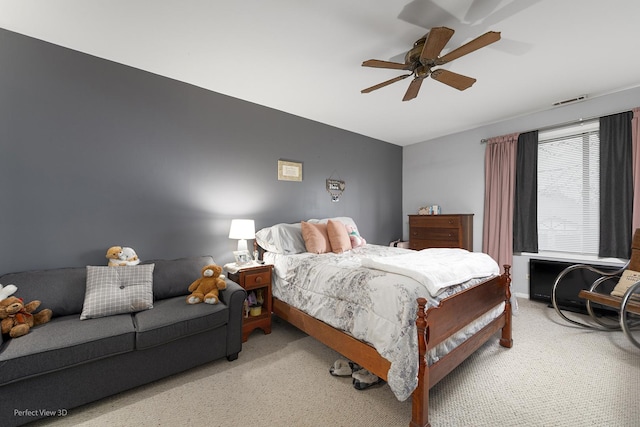 bedroom with light carpet, a ceiling fan, and visible vents
