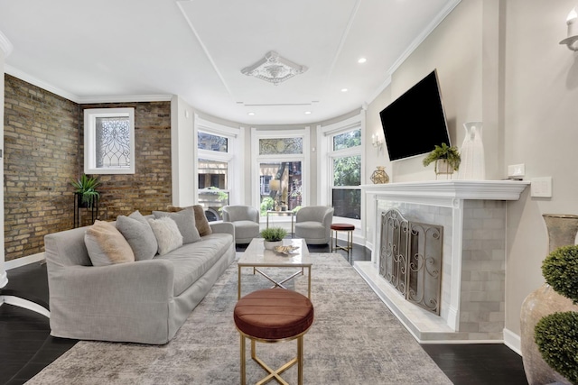 435 W Roslyn Pl Unit 2E, Chicago, IL 60614 - living area featuring wood finished floors, ornamental molding, a fireplace with raised hearth, brick wall, and recessed lighting