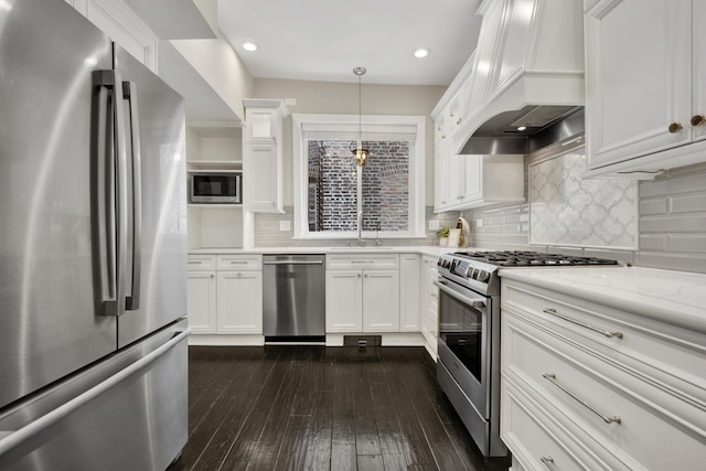 435 W Roslyn Pl Unit 2E, Chicago, IL 60614 - kitchen featuring stainless steel appliances, custom range hood, white cabinets, dark wood finished floors, and recessed lighting