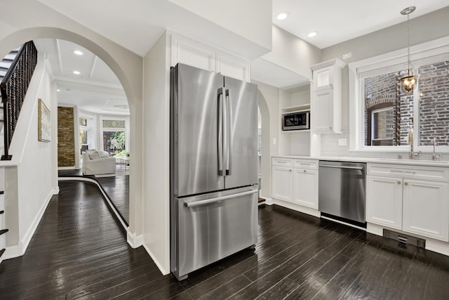 435 W Roslyn Pl Unit 2E, Chicago, IL 60614 - kitchen with appliances with stainless steel finishes, arched walkways, dark wood-type flooring, white cabinets, and recessed lighting