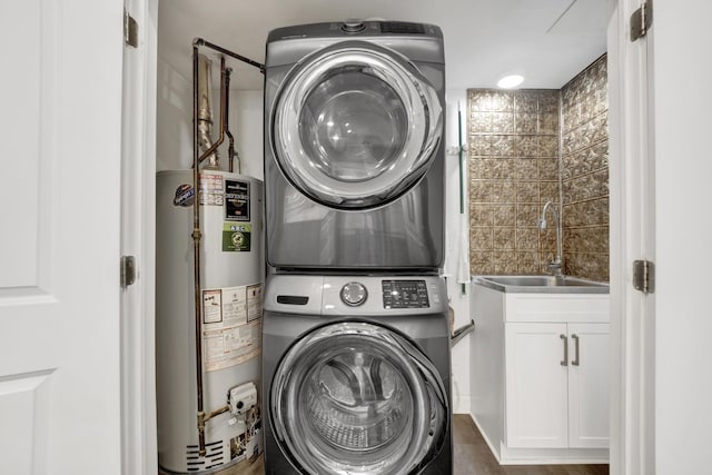 435 W Roslyn Pl Unit 2E, Chicago, IL 60614 - laundry room with gas water heater, stacked washer and clothes dryer, and cabinet space