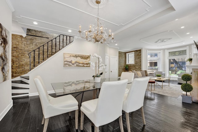 435 W Roslyn Pl Unit 2E, Chicago, IL 60614 - dining space with stairway, wood finished floors, a tray ceiling, brick wall, and a chandelier