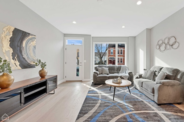 living room featuring wood finished floors, baseboards, and recessed lighting