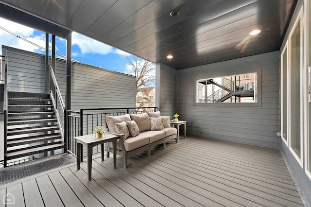 wooden terrace featuring an outdoor living space and stairs