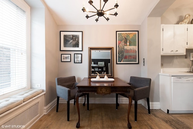 dining space featuring a chandelier, light wood finished floors, plenty of natural light, and baseboards