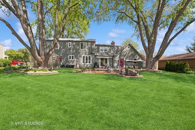 29W107 Lakeside Dr, Naperville, IL 60564 - back of property with a chimney, a yard, and a patio