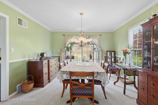 29W107 Lakeside Dr, Naperville, IL 60564 - carpeted dining room featuring an inviting chandelier, visible vents, and ornamental molding