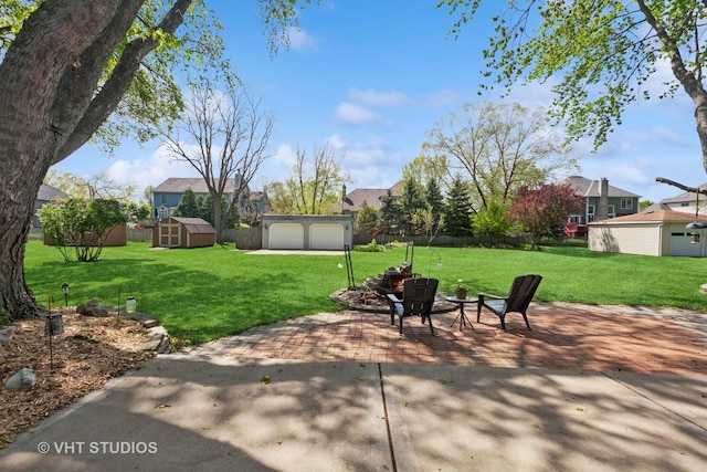 29W107 Lakeside Dr, Naperville, IL 60564 - view of patio with an outbuilding, a detached garage, a storage shed, and fence