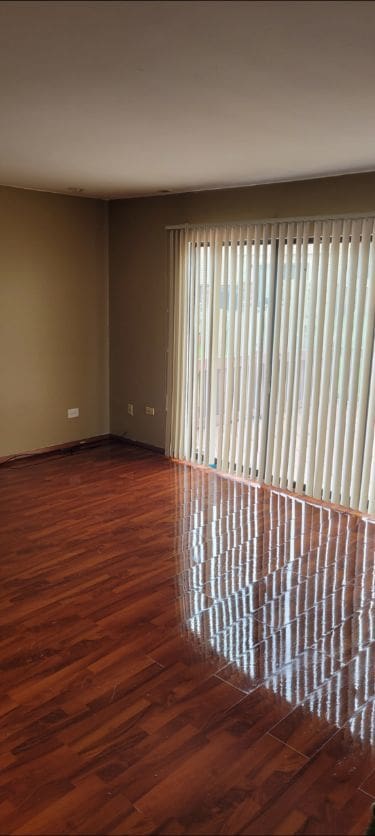 unfurnished room with baseboards and wood finished floors