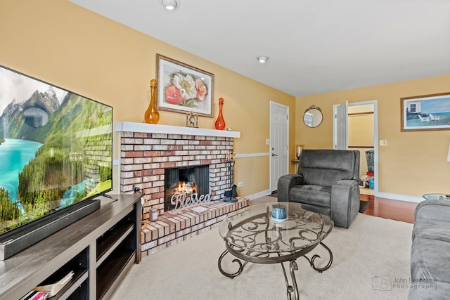 living room featuring baseboards, a fireplace, and wood finished floors