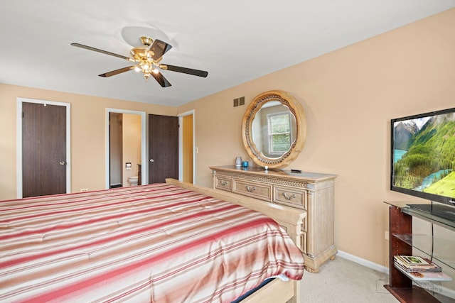 bedroom featuring light colored carpet, baseboards, and a ceiling fan