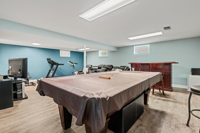 playroom featuring wood finished floors, pool table, a bar, and baseboards