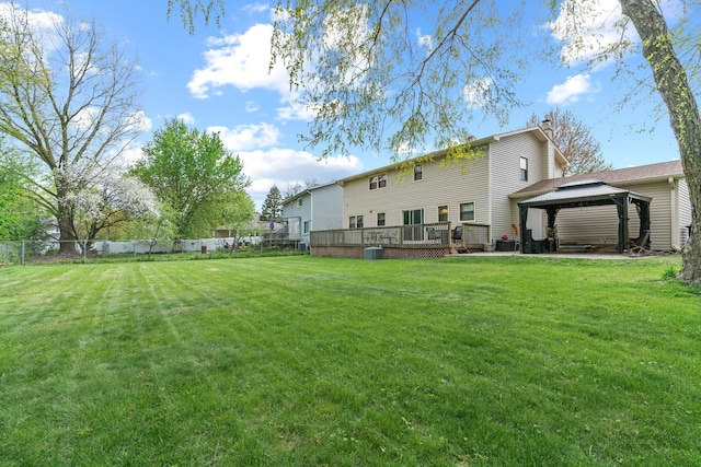 view of yard featuring a gazebo, a wooden deck, and central air condition unit