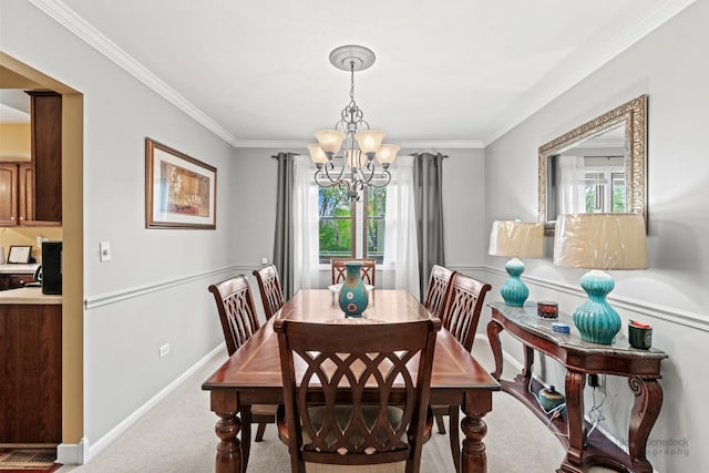 carpeted dining room with healthy amount of natural light, a chandelier, ornamental molding, and baseboards