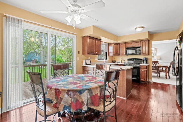 dining room featuring dark wood finished floors and ceiling fan