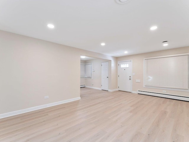 unfurnished living room featuring light wood-style flooring, baseboards, and recessed lighting