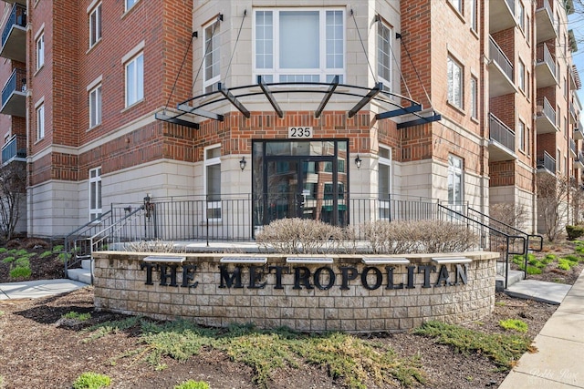 view of exterior entry with brick siding