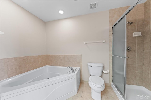 bathroom featuring a stall shower, tile patterned flooring, toilet, and visible vents