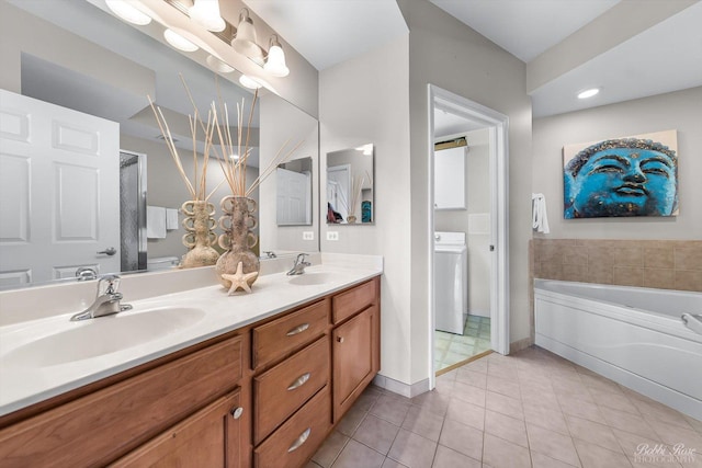 235 N Smith St Unit 509, Palatine, IL 60067 - bathroom featuring washer / clothes dryer, tile patterned floors, double vanity, a bath, and baseboards