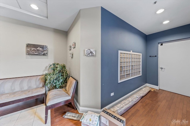 foyer entrance featuring baseboards, recessed lighting, and wood finished floors