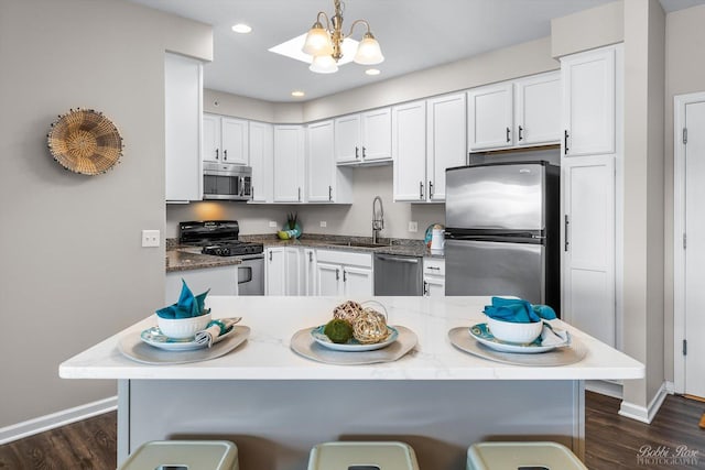 235 N Smith St Unit 509, Palatine, IL 60067 - kitchen with stainless steel appliances, baseboards, a sink, a kitchen breakfast bar, and recessed lighting