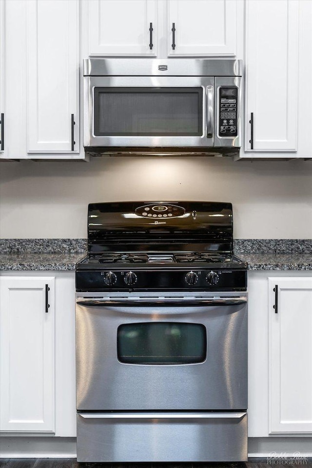 235 N Smith St Unit 509, Palatine, IL 60067 - kitchen featuring appliances with stainless steel finishes, white cabinets, and dark stone countertops