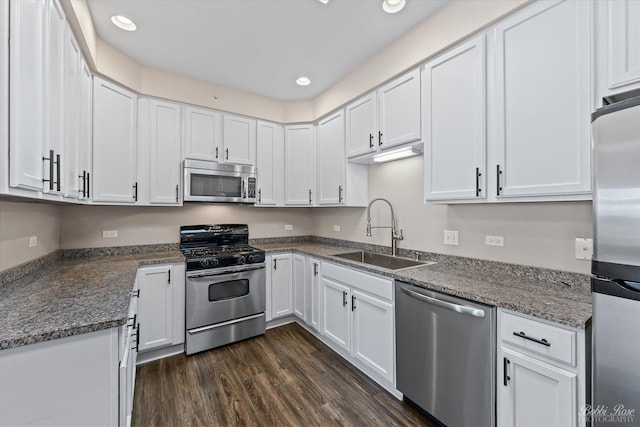 kitchen with recessed lighting, a sink, white cabinetry, dark wood-type flooring, and appliances with stainless steel finishes