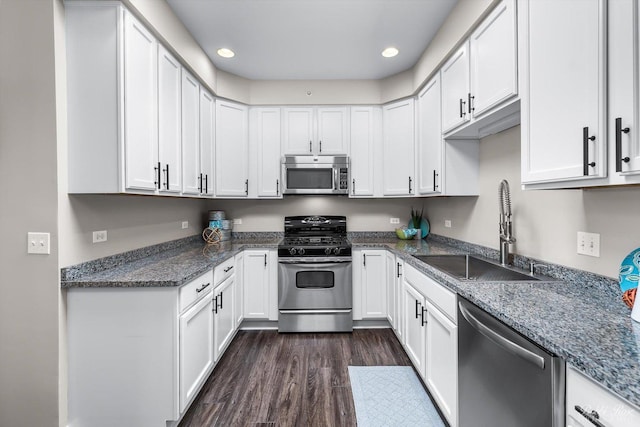235 N Smith St Unit 509, Palatine, IL 60067 - kitchen featuring appliances with stainless steel finishes, a sink, dark wood-type flooring, white cabinets, and dark stone counters