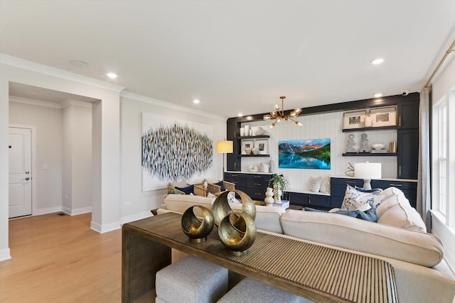 living room with recessed lighting, baseboards, a notable chandelier, and light wood-style floors