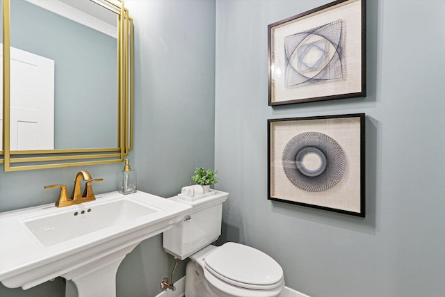 bathroom with toilet and a sink