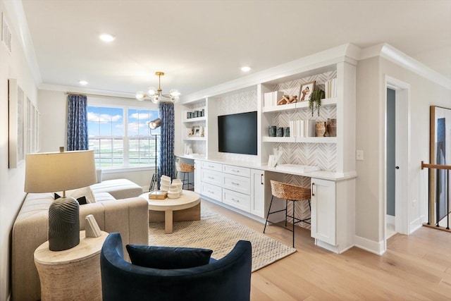 living room with crown molding, a notable chandelier, built in desk, light wood-style floors, and recessed lighting