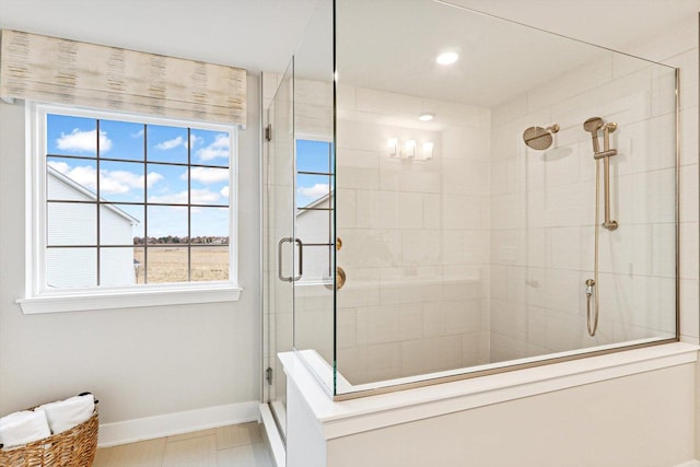 full bathroom with a healthy amount of sunlight, baseboards, a stall shower, and recessed lighting