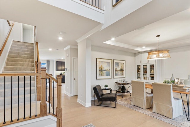 interior space featuring light wood-style floors, ornamental molding, recessed lighting, and stairway