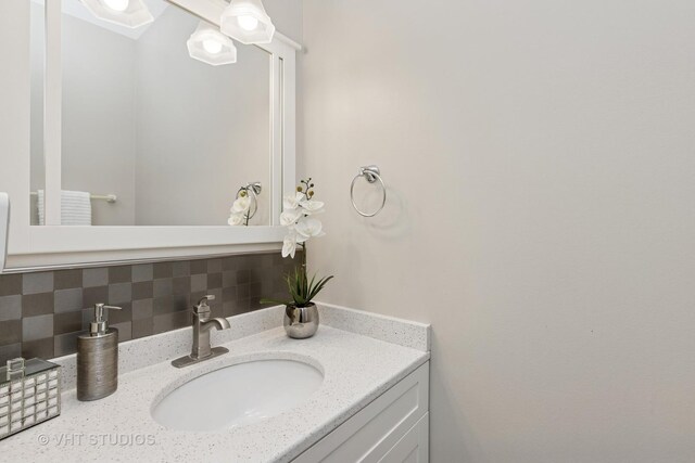 bathroom featuring tasteful backsplash and vanity