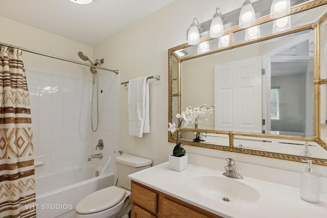 bathroom with toilet, vanity, and shower / bathtub combination with curtain