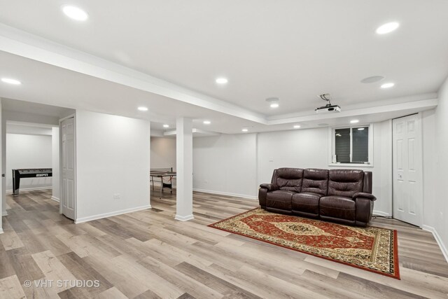 living room featuring light wood-style floors, baseboards, and recessed lighting