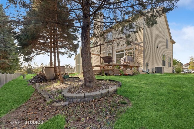 view of yard with a wooden deck and central AC unit