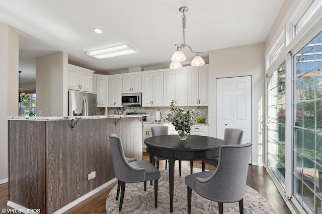 dining area with dark wood finished floors