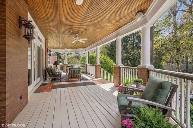 wooden deck with a ceiling fan and covered porch