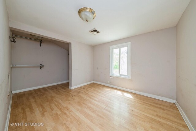 561 S Drive Drive S, Elgin, IL 60177 - unfurnished bedroom featuring wood finished floors, baseboards, and a closet