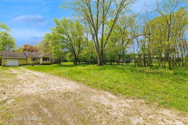 561 S Drive Drive S, Elgin, IL 60177 - view of yard with an attached garage and dirt driveway